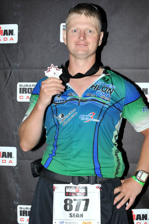 Kintec's Maple Ridge Run Clinic Instructor Sean Wilson with a medal from Ironman Canada, 2010